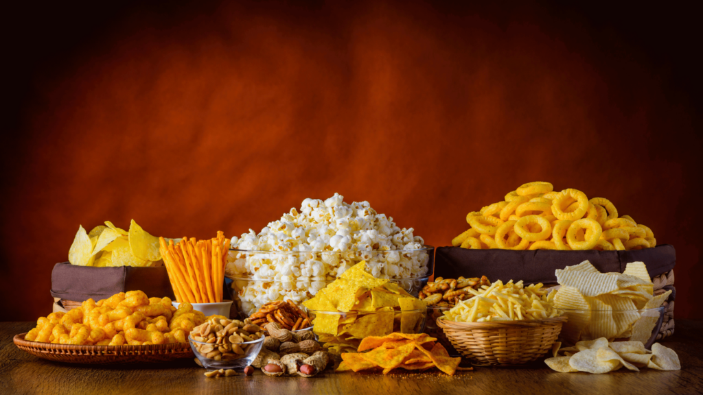 Industry Diversification In Snacking Blog Image; Bowls of diverse snacks such as popcorn, nuts, veggie sticks.
