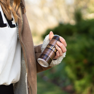 A can of Jude's Chocolate Milkshake in a womans hand