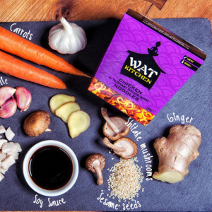 A Wat Kitchen meal box surrounded by a range of ingredients
